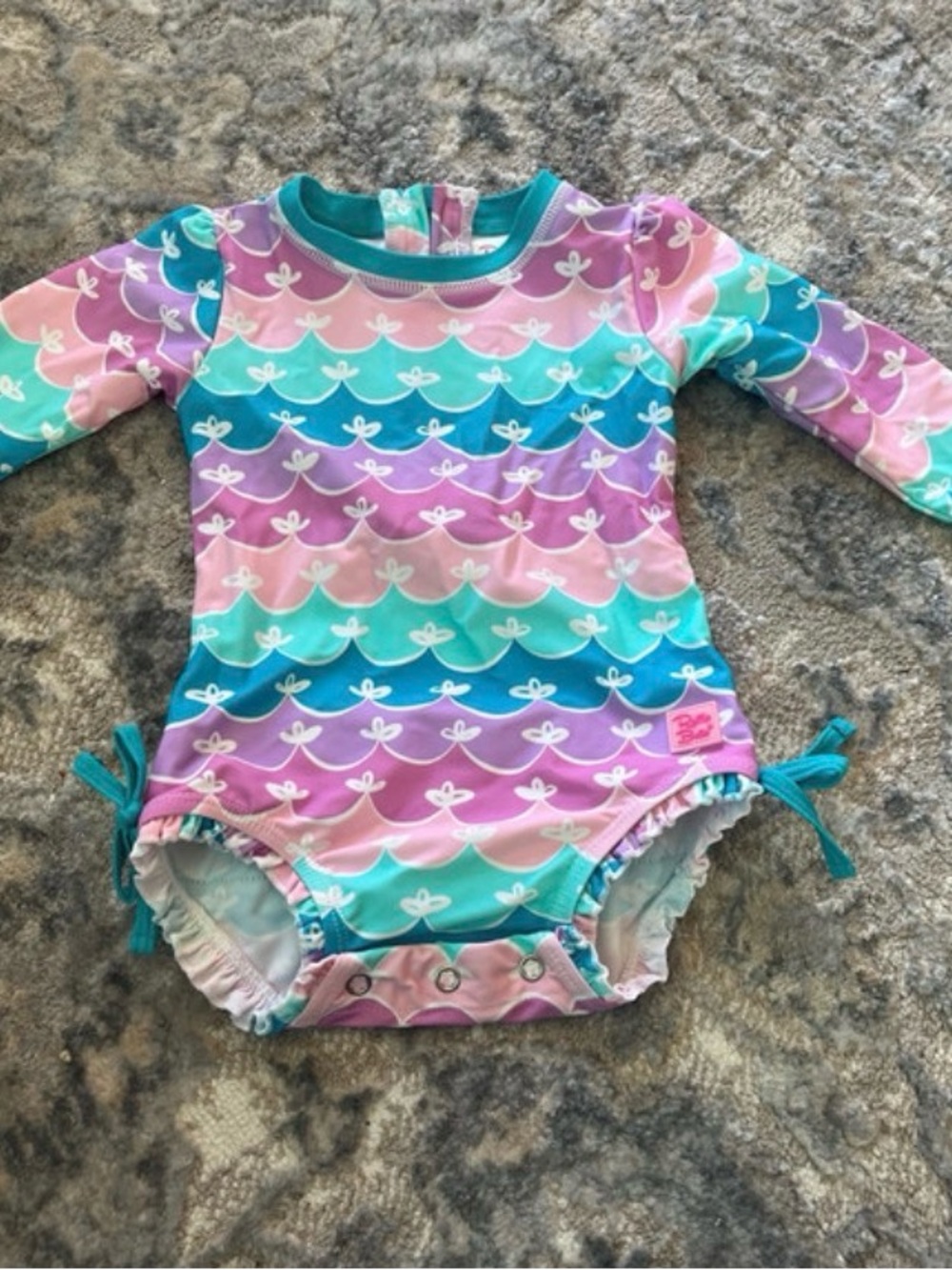 Ruffle Butts Pastel Mermaid Wave Long-Sleeve One-Piece in Teal, Purple, Pink